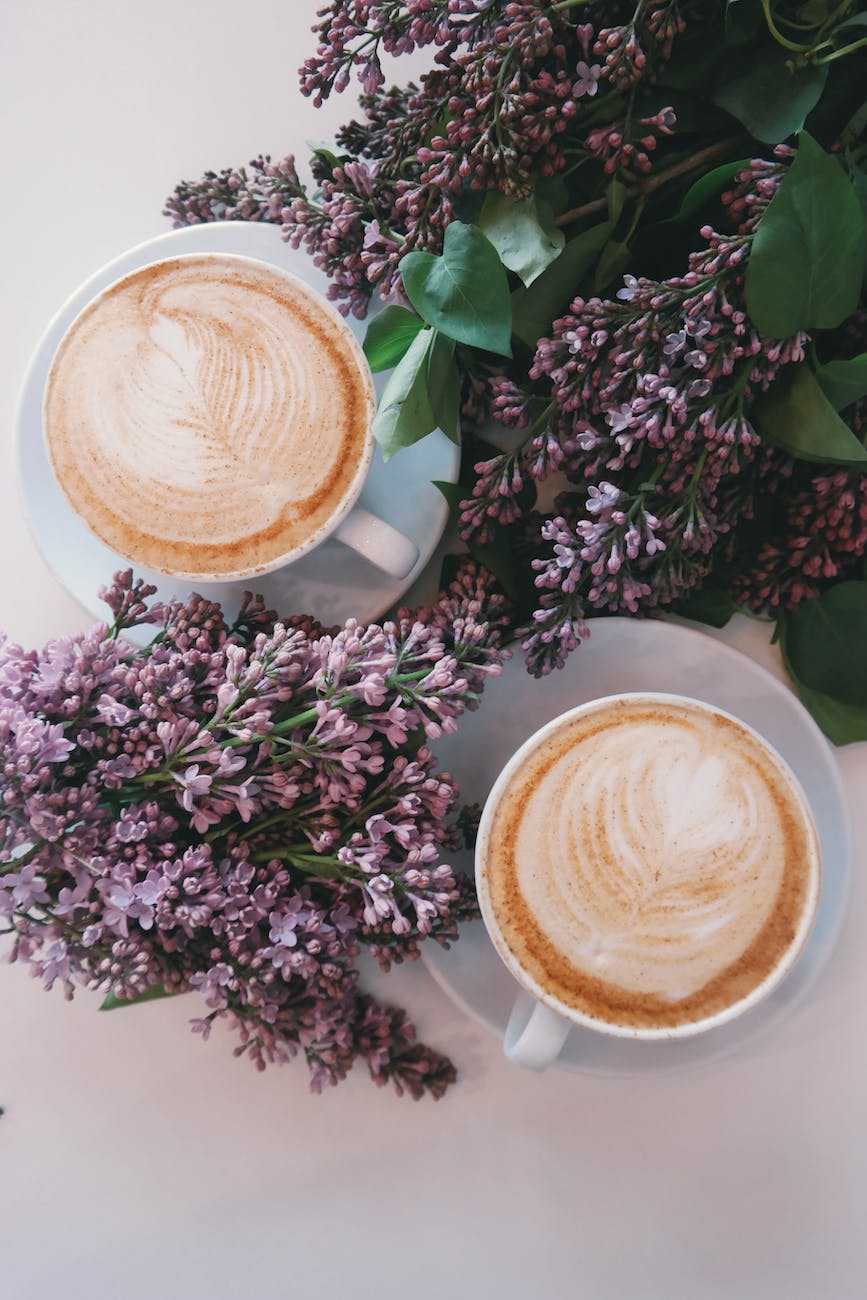 Two cups of coffee and flowers